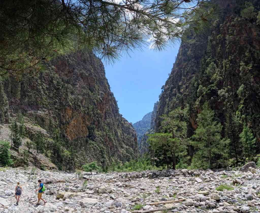 People hiking on trail through Samaria gorge. (Crete, Greece).